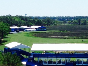 This is a view from the top of the lighthouse of the 18th hole of the PGA Tour course. The green is directly in front of the buildings in the background and the green is behind the grandstand (the white roof) in the foreground of the picture. I'm told that golfers take aim at the lighthouse on their first drive from the tee. TV crews set up their cameras on the lighthouse where I stood to take this picture to film the golfers playing the 18th hole in the PGA Tournament.
